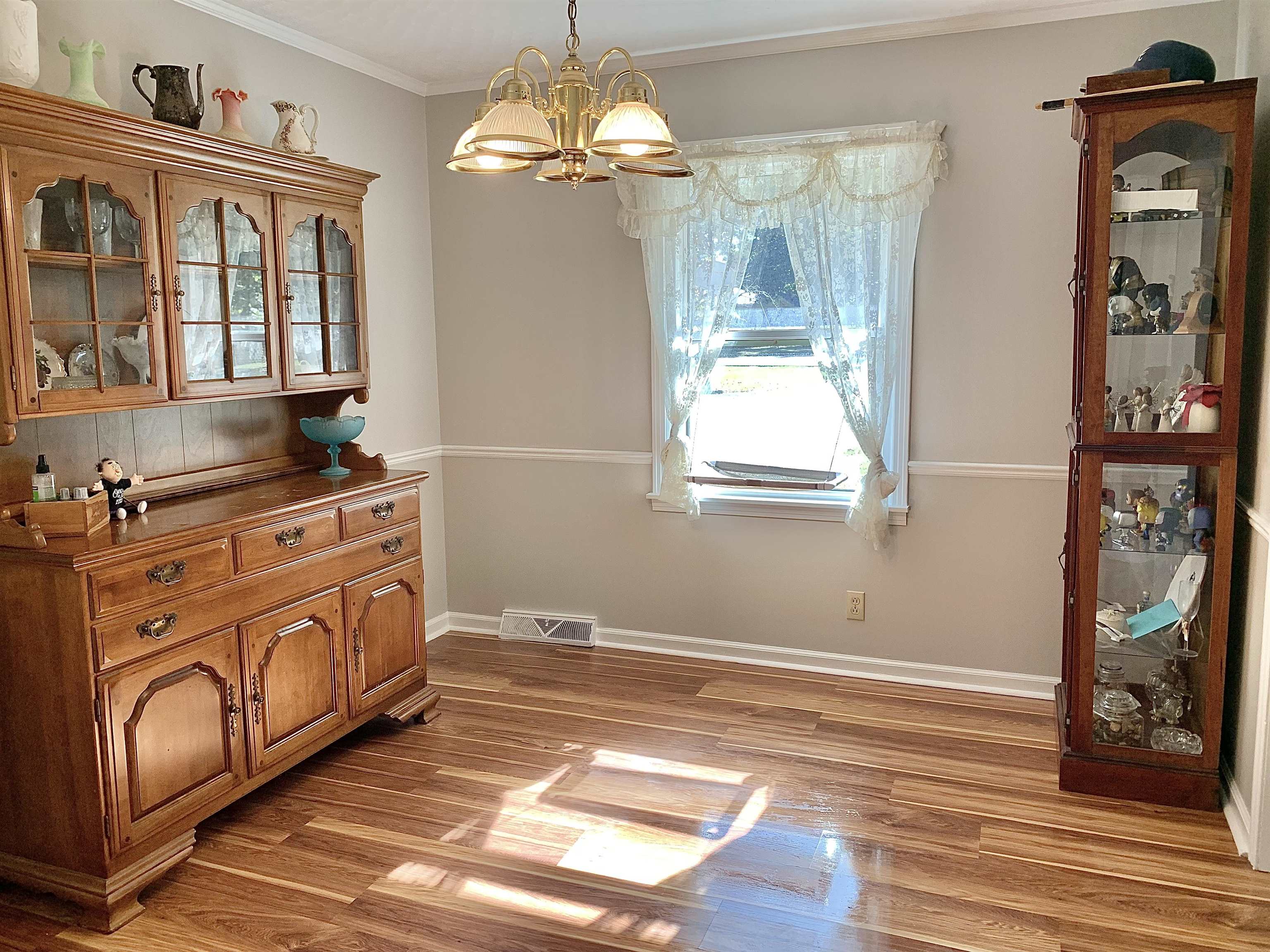 1038 Lake Street Bolivar, TN 38008 - Photo 8 of 31 Dining space with ornamental molding, a chandelier, and light hardwood / wood-style floors