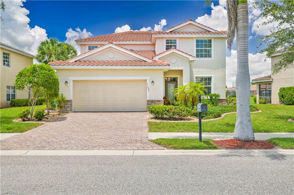 11686 Eros Road Lehigh Acres, FL 33971 - Photo 1 of 44 a front view of a house with a yard and garage