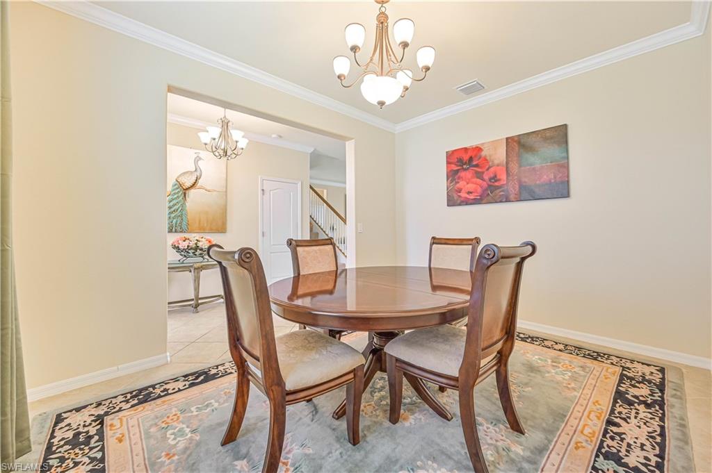 11686 Eros Road Lehigh Acres, FL 33971 - Photo 12 of 44 a view of a dining room with furniture and wooden floor