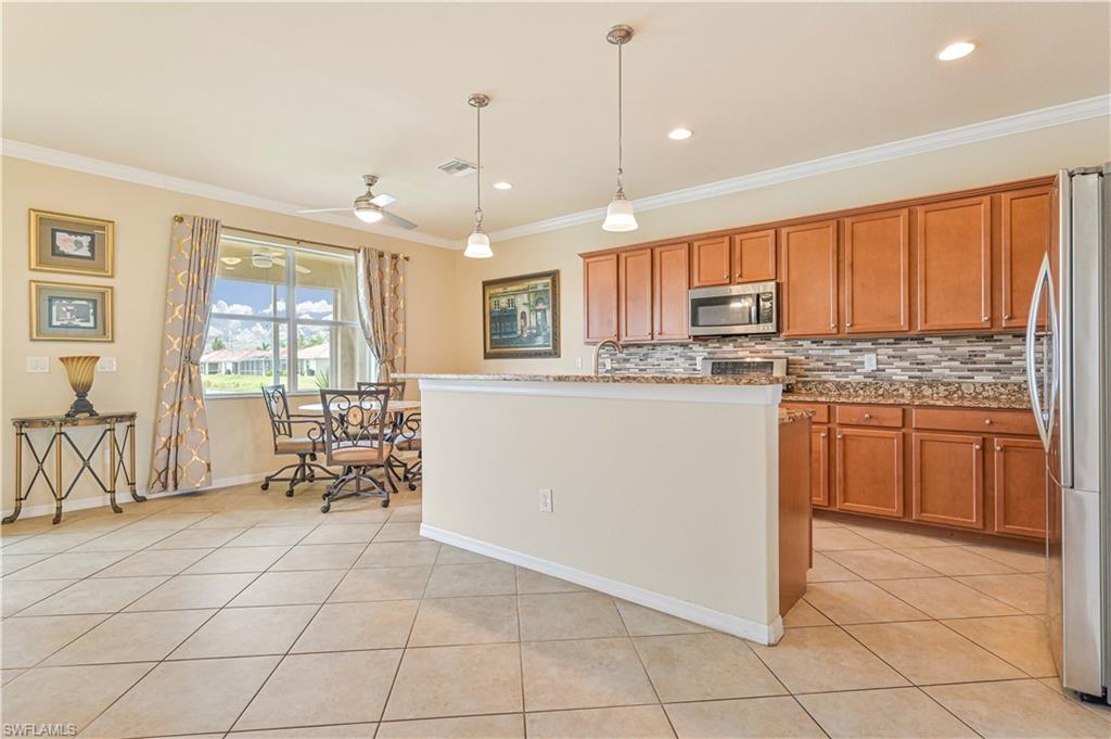 11686 Eros Road Lehigh Acres, FL 33971 - Photo 13 of 44 a kitchen with cabinets and chairs
