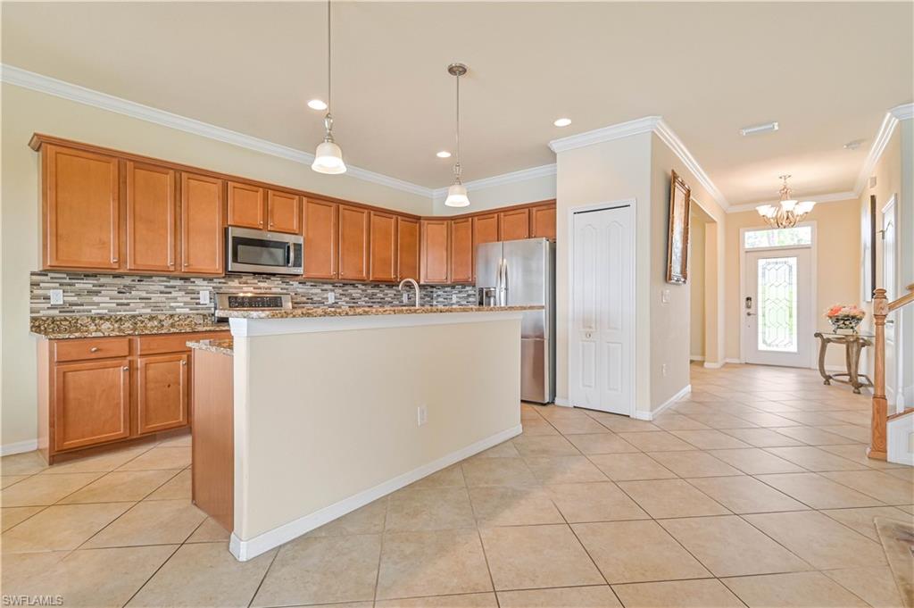 11686 Eros Road Lehigh Acres, FL 33971 - Photo 14 of 44 a kitchen with kitchen island granite countertop appliances cabinets and a sink