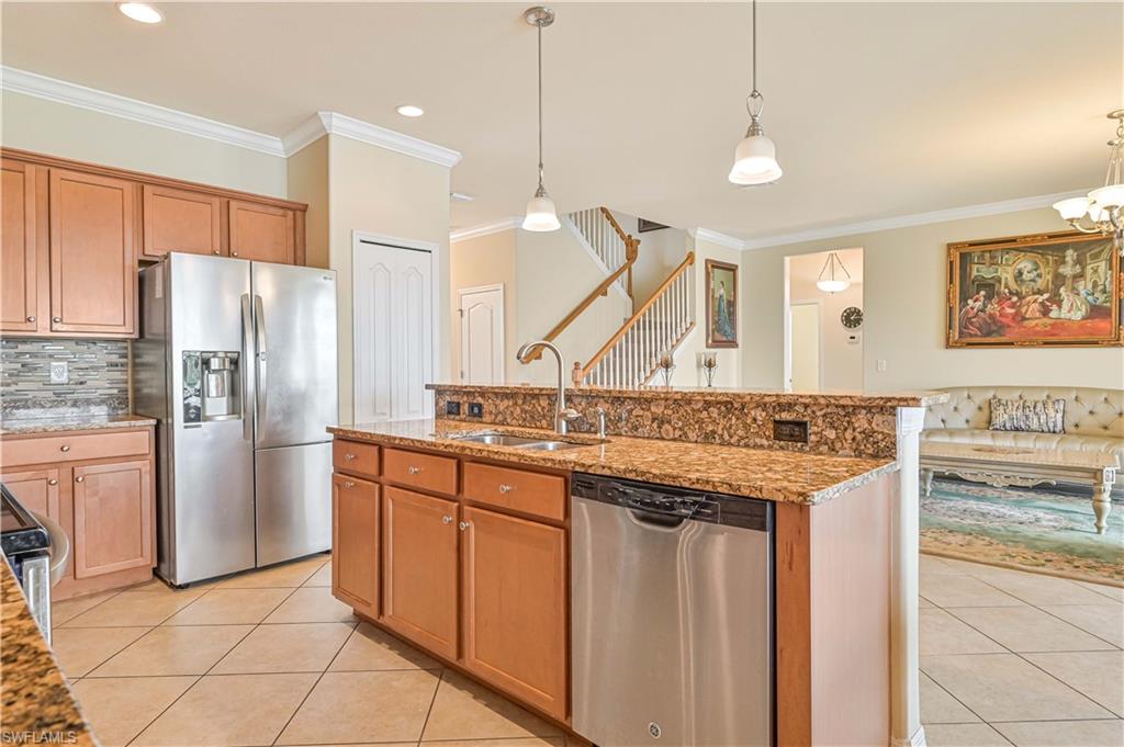 11686 Eros Road Lehigh Acres, FL 33971 - Photo 16 of 44 a kitchen with stainless steel appliances granite countertop a sink a stove a refrigerator and island with wooden floor