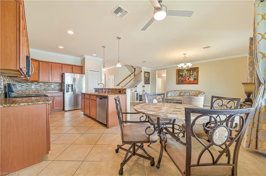 11686 Eros Road Lehigh Acres, FL 33971 - Photo 18 of 44 a view of a kitchen with dining table and chairs