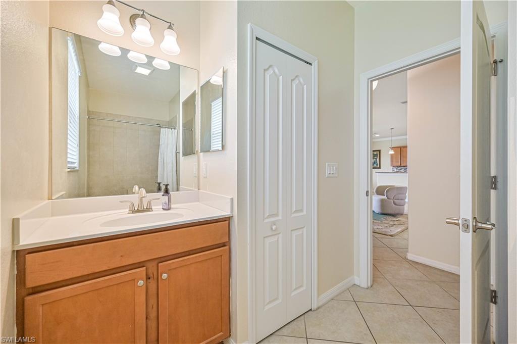 11686 Eros Road Lehigh Acres, FL 33971 - Photo 19 of 44 a bathroom with a sink vanity and a mirror