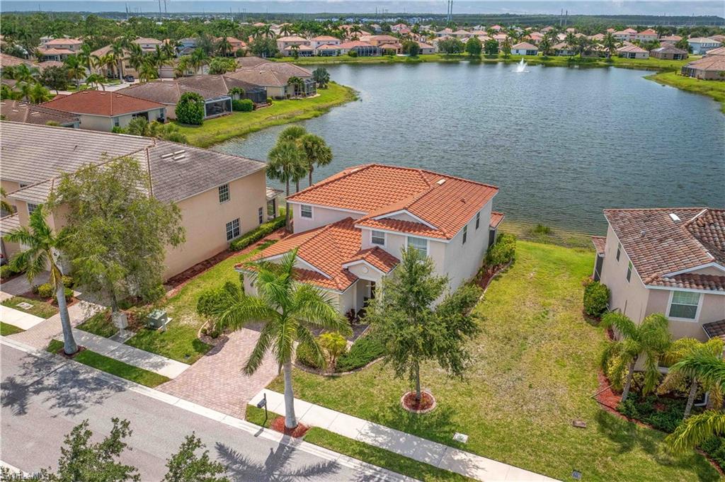 11686 Eros Road Lehigh Acres, FL 33971 - Photo 2 of 44 an aerial view of residential houses with outdoor space and lake view
