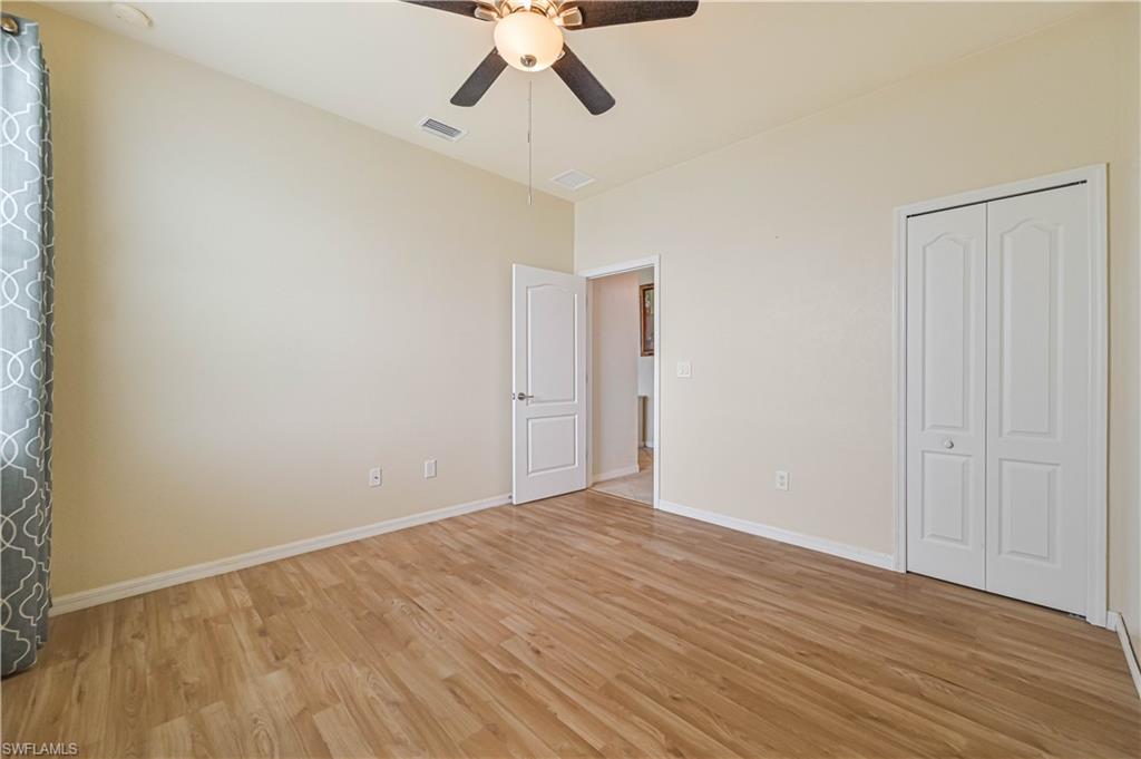 11686 Eros Road Lehigh Acres, FL 33971 - Photo 21 of 44 a view of an empty room with wooden floor