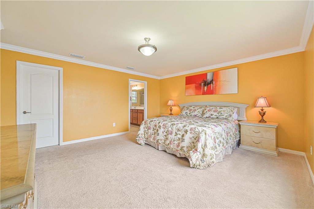 11686 Eros Road Lehigh Acres, FL 33971 - Photo 28 of 44 a bedroom with a bed and painting on the wall