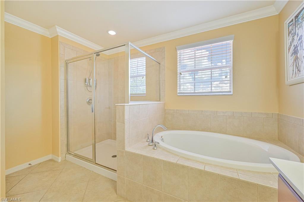 11686 Eros Road Lehigh Acres, FL 33971 - Photo 30 of 44 a bathroom with a bathtub and a shower