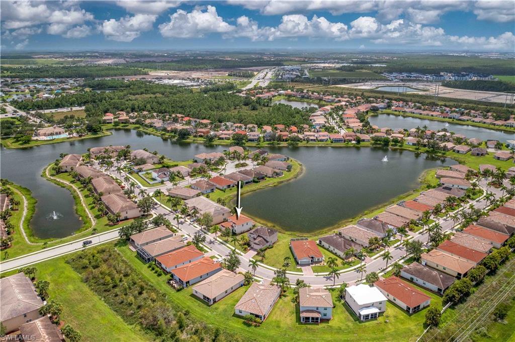 11686 Eros Road Lehigh Acres, FL 33971 - Photo 3 of 44 an aerial view of residential houses with outdoor space and lake view