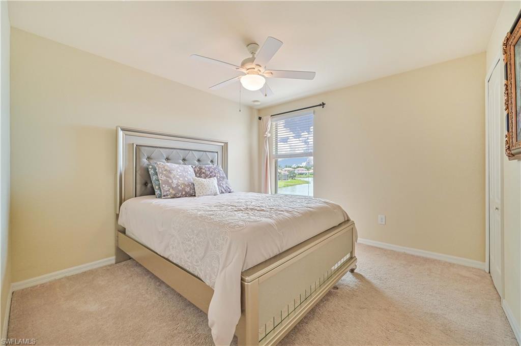 11686 Eros Road Lehigh Acres, FL 33971 - Photo 31 of 44 a bedroom with a bed and a ceiling fan