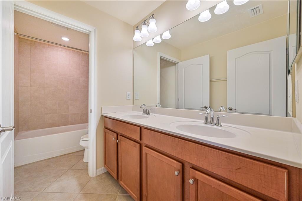 11686 Eros Road Lehigh Acres, FL 33971 - Photo 33 of 44 a bathroom with a tub sink and mirror