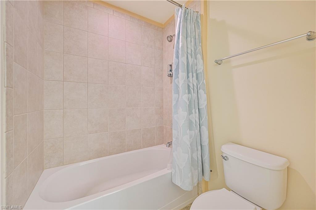 11686 Eros Road Lehigh Acres, FL 33971 - Photo 34 of 44 a bathroom with a toilet and a bathtub