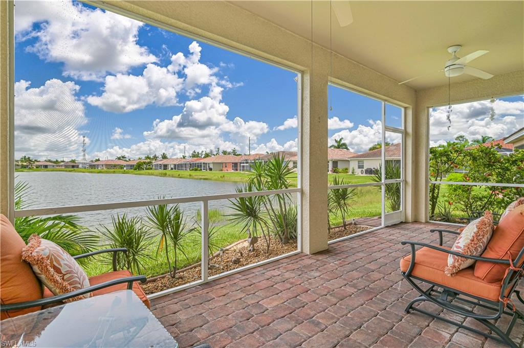 11686 Eros Road Lehigh Acres, FL 33971 - Photo 36 of 44 a view of a chairs and table in patio with a lake view