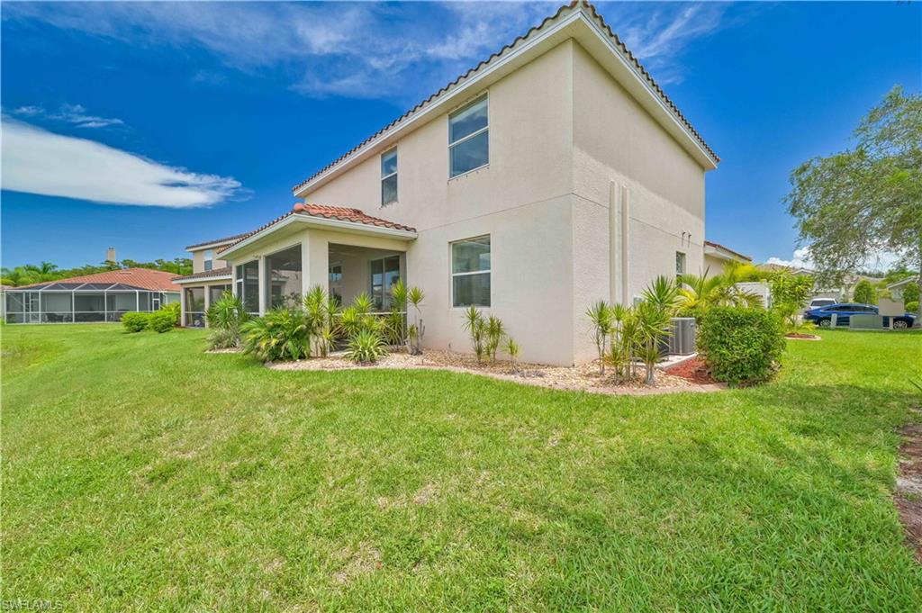 11686 Eros Road Lehigh Acres, FL 33971 - Photo 37 of 44 a view of a house with a yard and sitting area