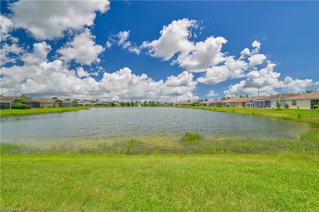 11686 Eros Road Lehigh Acres, FL 33971 - Photo 38 of 44 a view of a lake with houses in the back