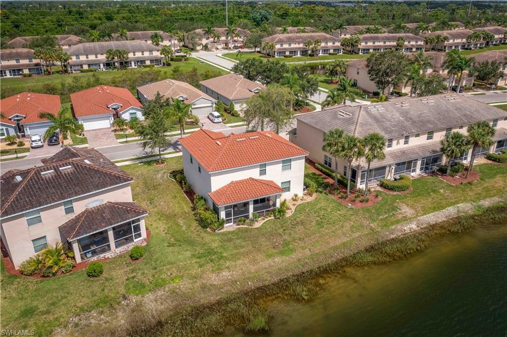 11686 Eros Road Lehigh Acres, FL 33971 - Photo 39 of 44 an aerial view of residential houses with outdoor space and lake view