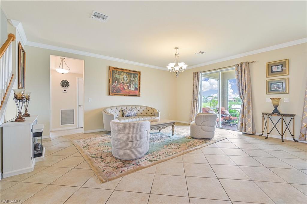 11686 Eros Road Lehigh Acres, FL 33971 - Photo 9 of 44 a living room with patio furniture and a dining table