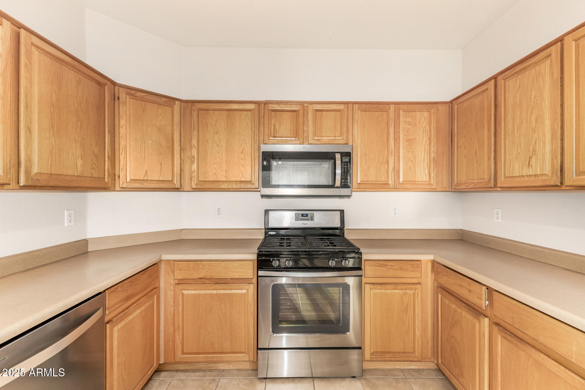 3622 South Joshua Tree Lane Gilbert, AZ 85297 - Photo 18 of 37 a kitchen with granite countertop white cabinets and stainless steel appliances