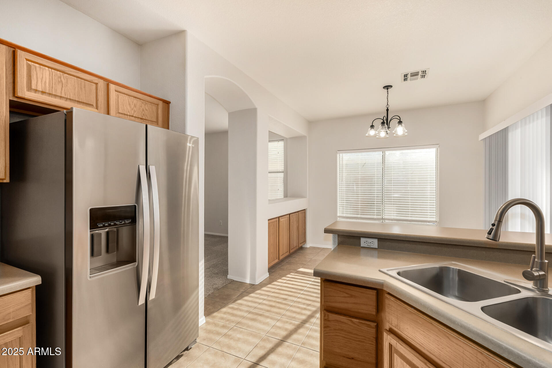 3622 South Joshua Tree Lane Gilbert, AZ 85297 - Photo 20 of 37 a kitchen with a refrigerator sink and cabinets