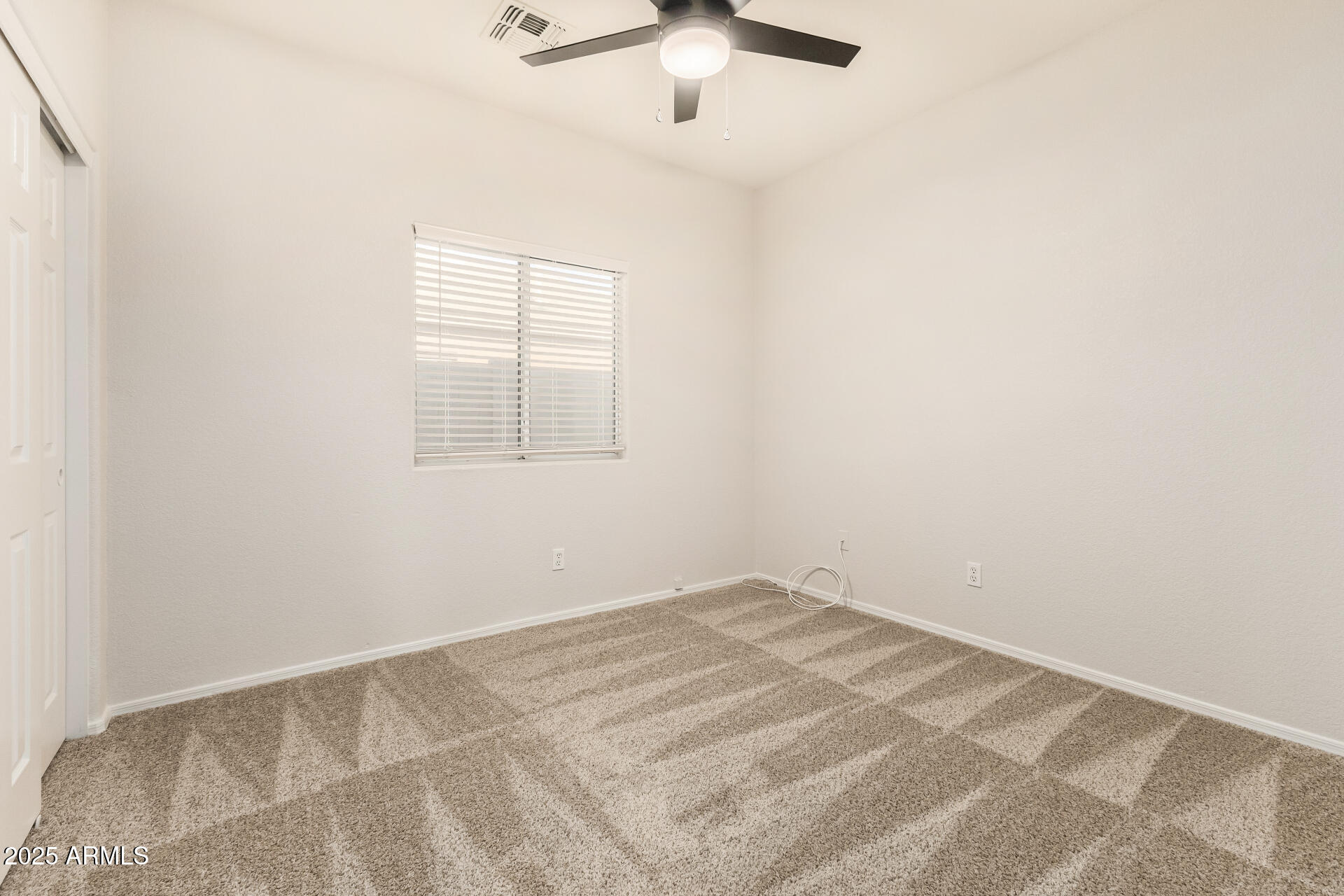 3622 South Joshua Tree Lane Gilbert, AZ 85297 - Photo 29 of 37 an empty room with a window and a fan