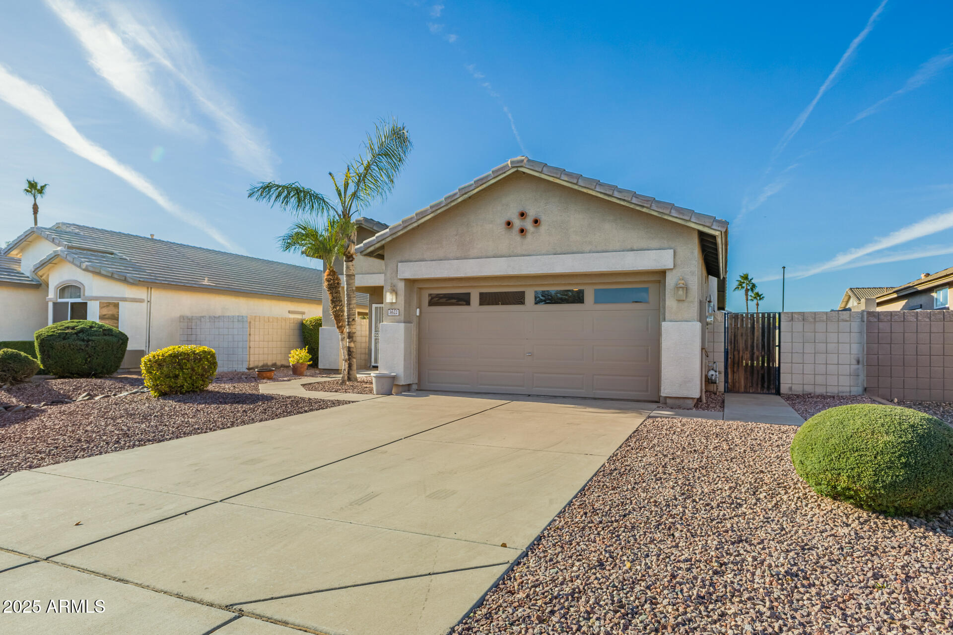 3622 South Joshua Tree Lane Gilbert, AZ 85297 - Photo 4 of 37 a front view of a house with a yard and garage