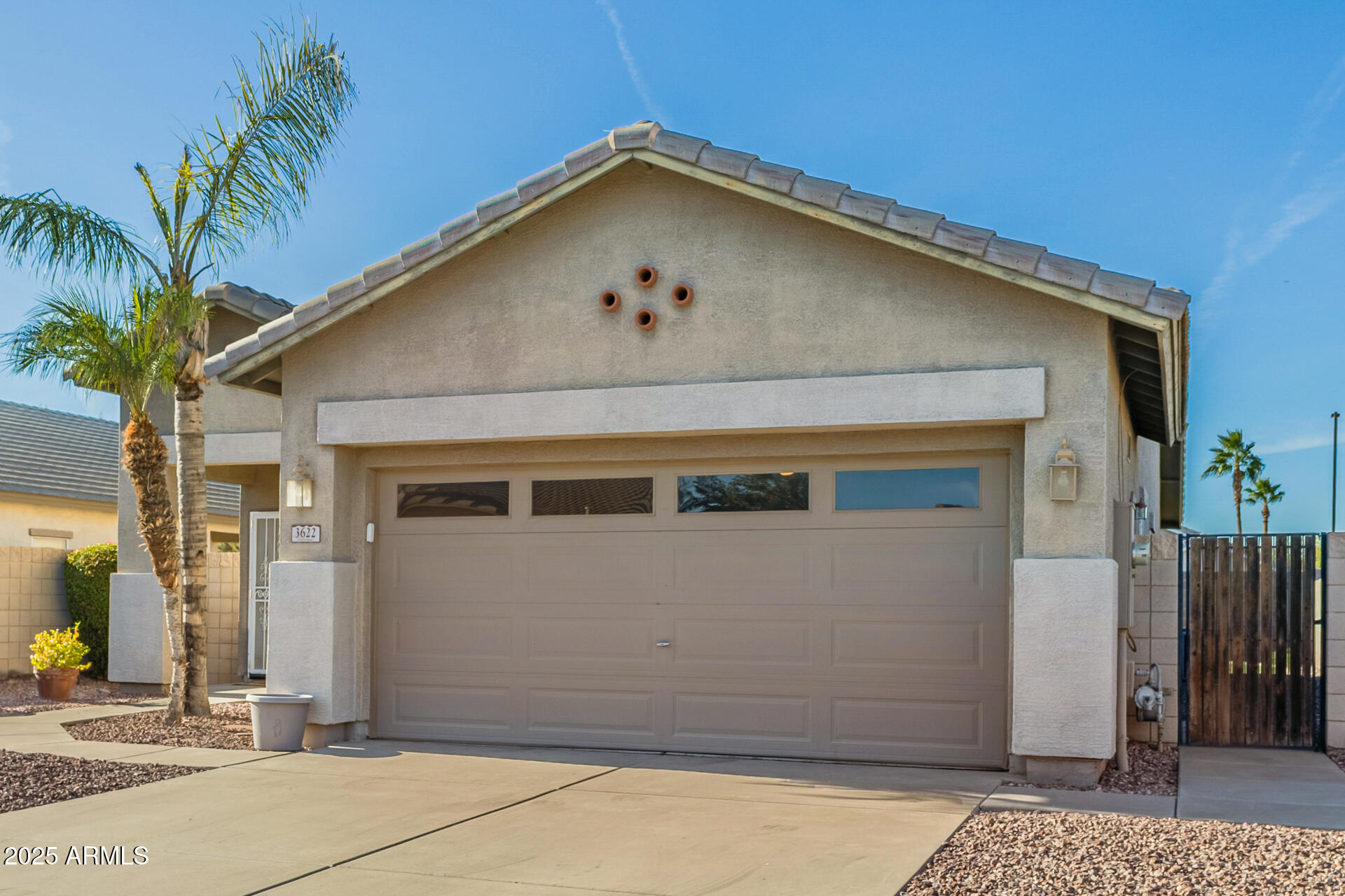 3622 South Joshua Tree Lane Gilbert, AZ 85297 - Photo 5 of 37 a front view of a house with a garage