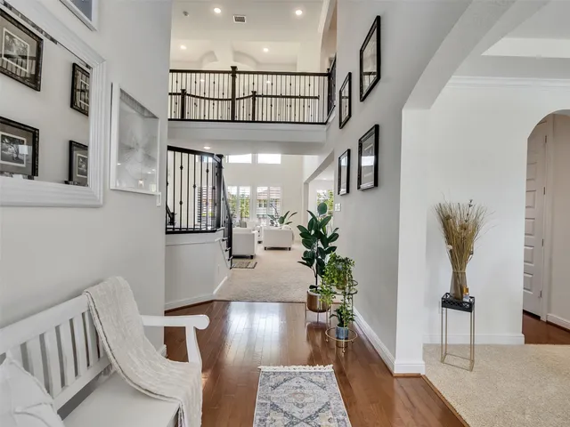 a kitchen with stainless steel appliances kitchen island granite countertop a stove a sink and white cabinets