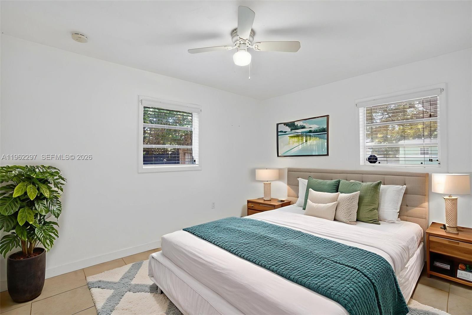 10325 Southwest 149th Terrace Miami, FL 33176 - Photo 12 of 34 a bedroom with a bed and a potted plant