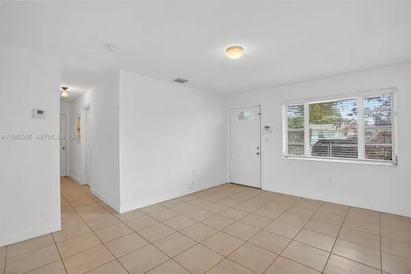 a kitchen with stainless steel appliances granite countertop a refrigerator a stove a sink and a microwave