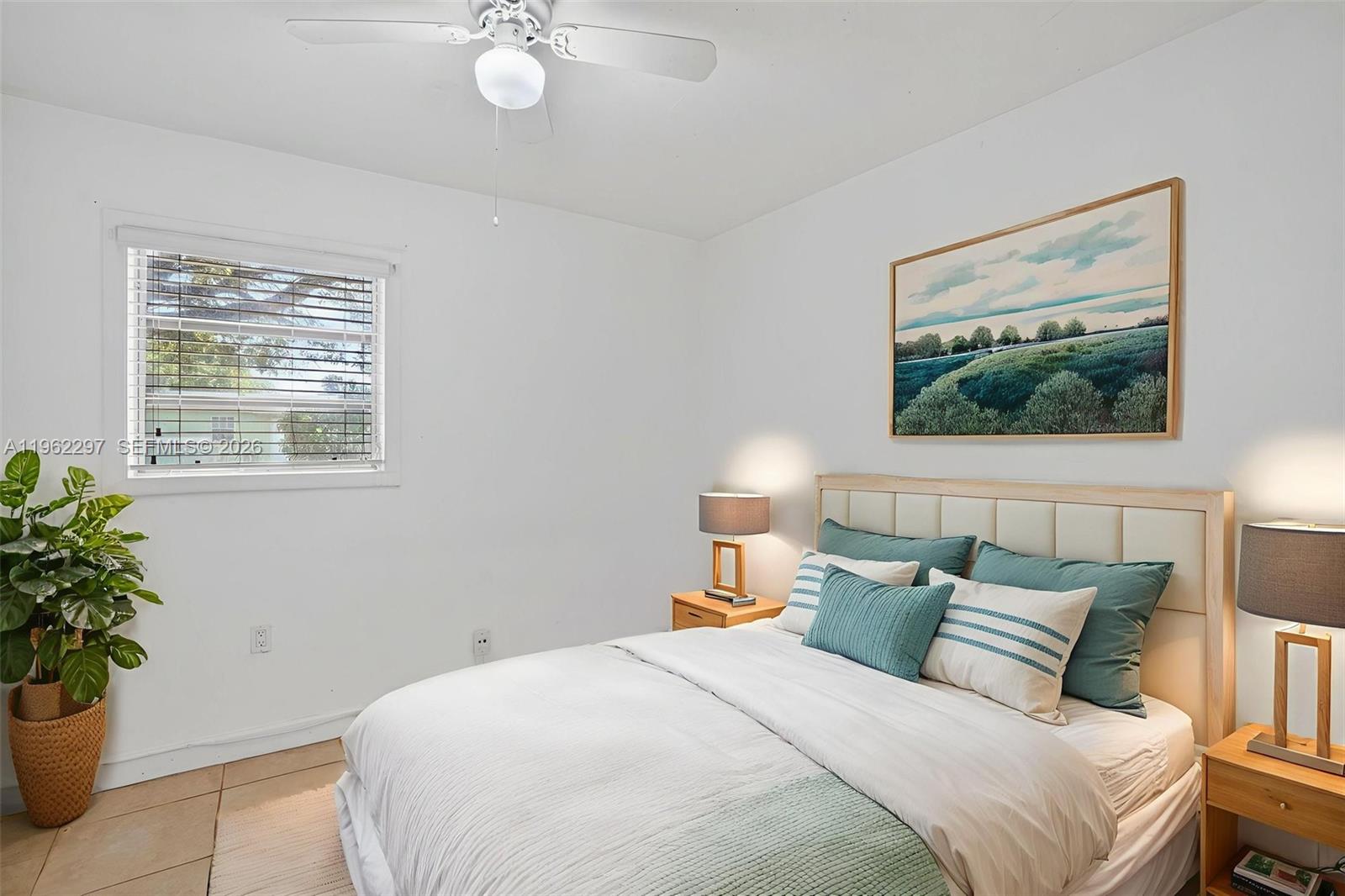 10325 Southwest 149th Terrace Miami, FL 33176 - Photo 34 of 34 a bedroom with a large bed and a potted plant