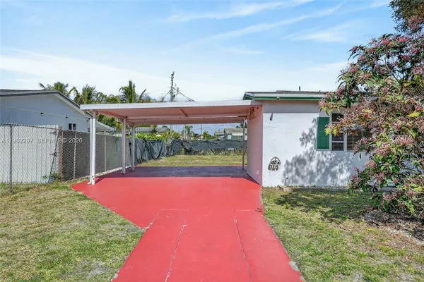 a front view of a house with swimming pool and a yard