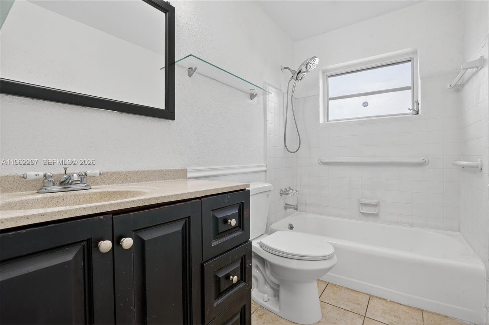 10325 Southwest 149th Terrace Miami, FL 33176 - Photo 7 of 34 a bathroom with a sink a toilet and shower