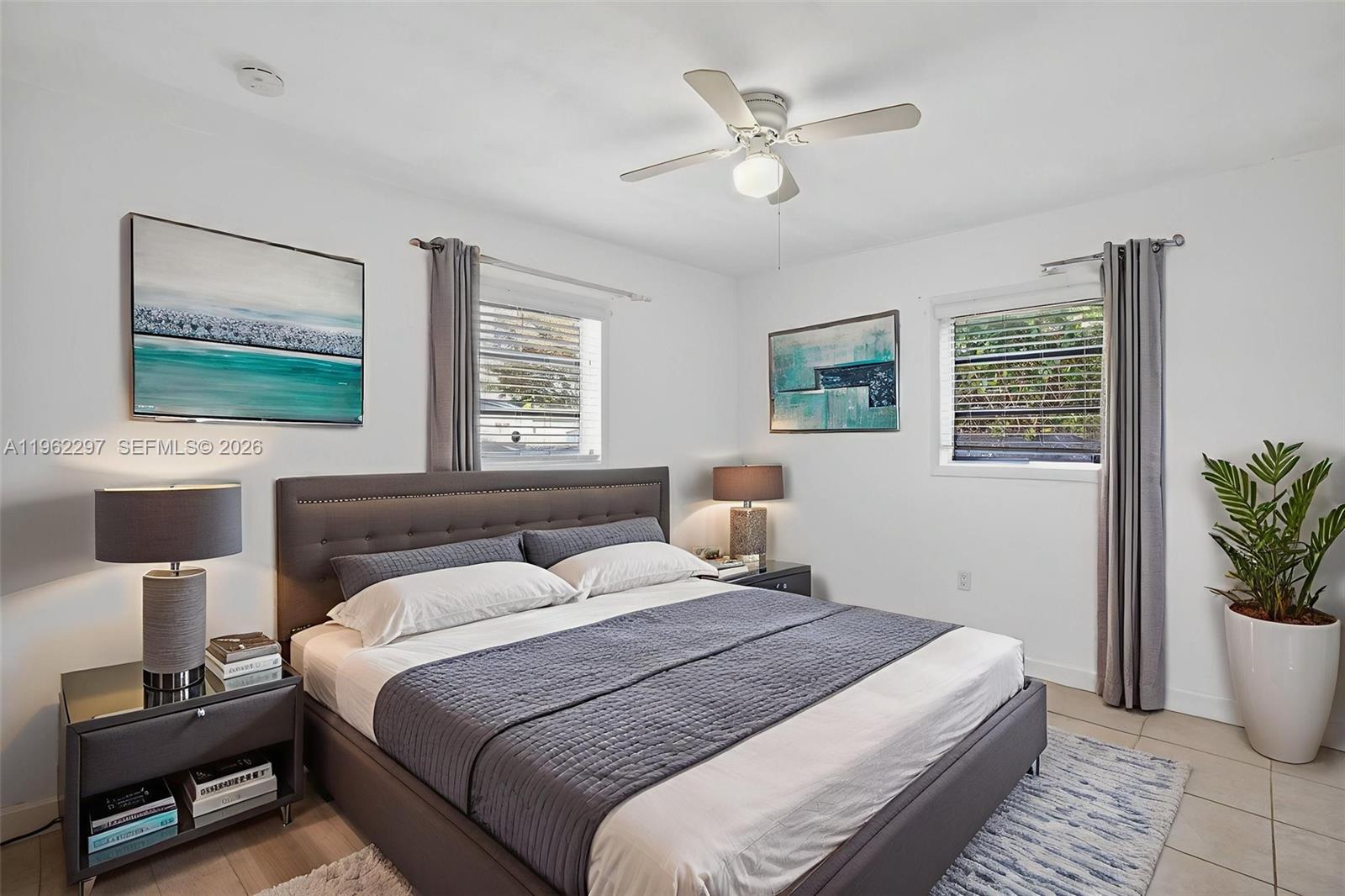 10325 Southwest 149th Terrace Miami, FL 33176 - Photo 9 of 34 a bedroom with a bed a window and potted plant