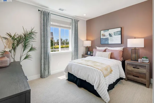 a bedroom with a bed and a potted plant