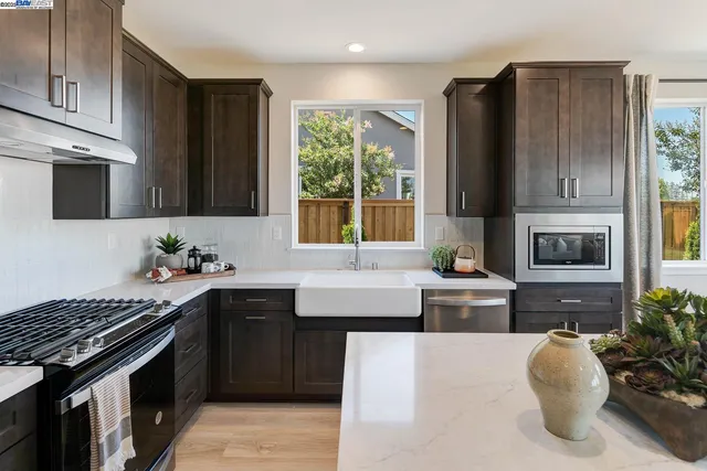 a kitchen with a sink stove and microwave