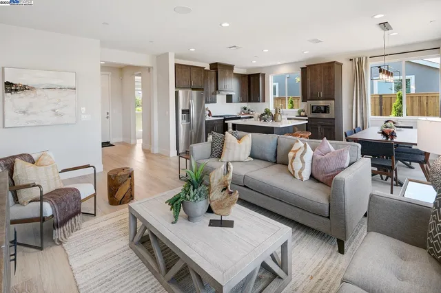 a living room with furniture and kitchen view