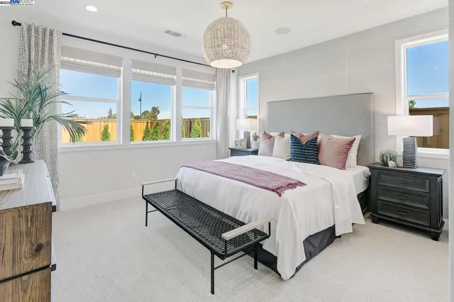 a bedroom with a bed potted plant with the window