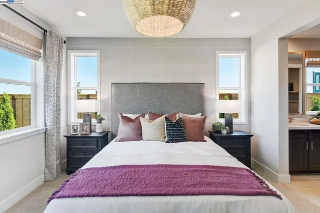 a bedroom with a large bed and a window