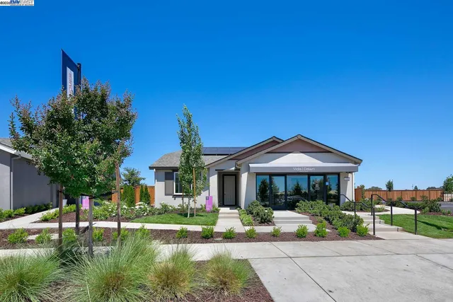 a front view of a house with a yard table and chairs