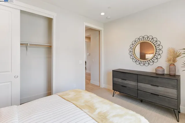 a bedroom with a bed and a mirror