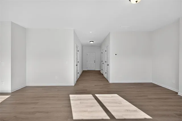 a view of a room with wooden floor and white walls