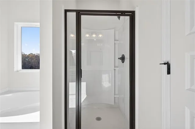 a bathroom with a glass shower door