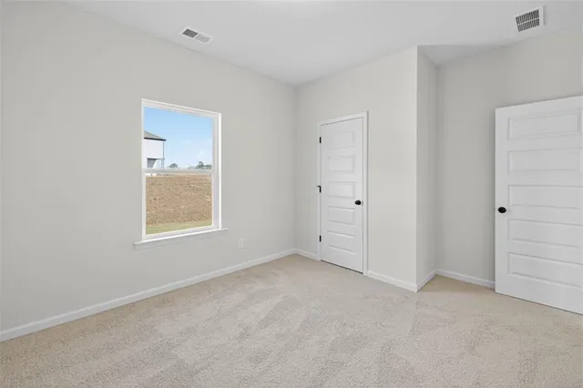 an empty room with windows and closet
