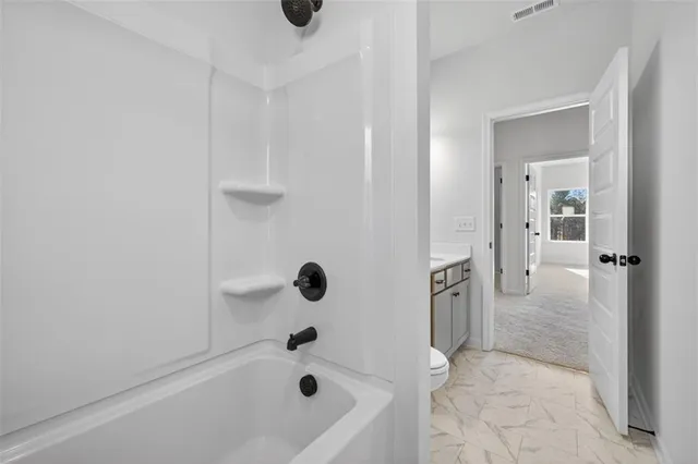 a bathroom with a bathtub and shower