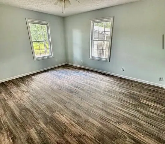 an empty room with windows and closet