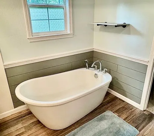 a bathroom with a sink toilet and mirror