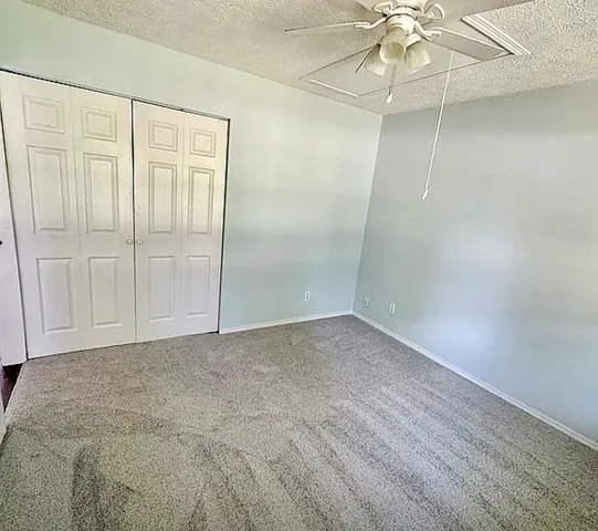 a kitchen with stainless steel appliances kitchen island granite countertop a table chairs sink and cabinets