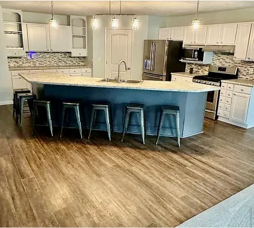 a view of a room with wooden floor