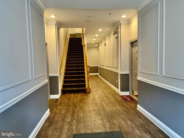 a view of entryway with wooden floor and stairs