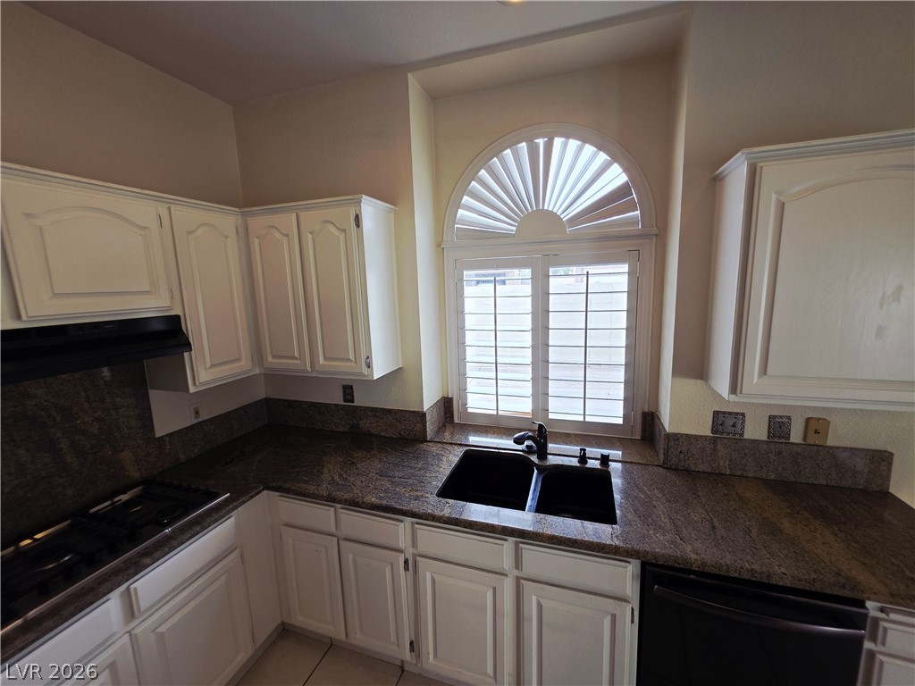 2920 Setting Sun Street Las Vegas, NV 89117 - Photo 15 of 43 This kitchen features elegant cabinetry, ample counter space, and an arched window for abundant natural light.